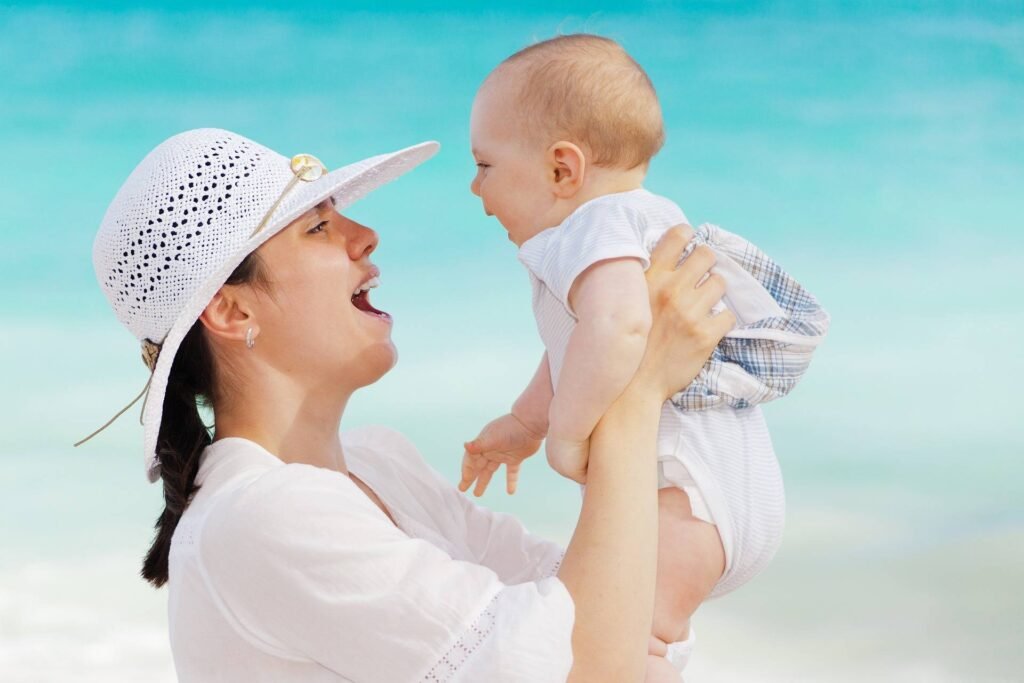 A mum holding her newborn baby smiling