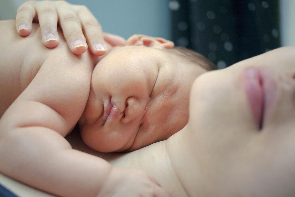 Mother sleeping with a newborn baby