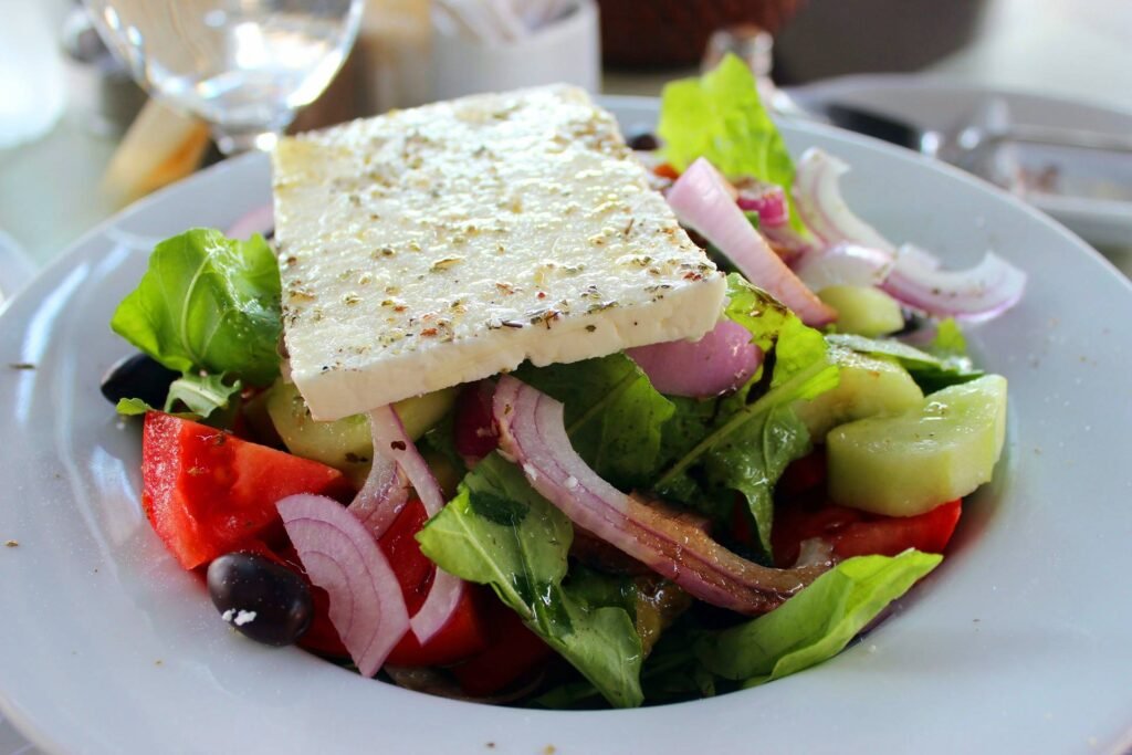 an image of block of feta cheese on top of a salad